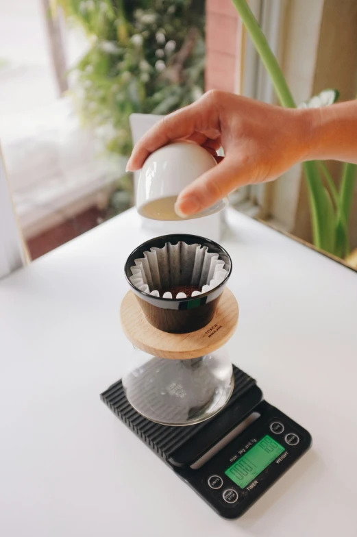 a person throwing an egg over a stove top on a scale