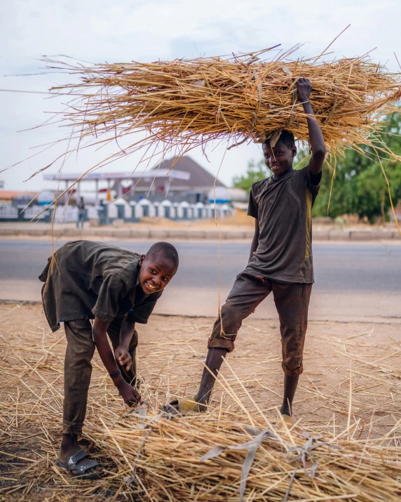 two young men are posing together in the hay