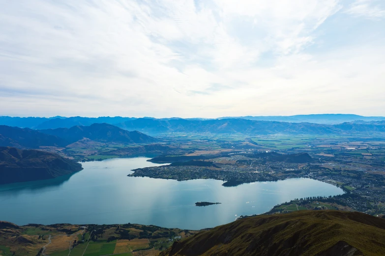 the view from the top of a mountain overlooking a lake and some mountains