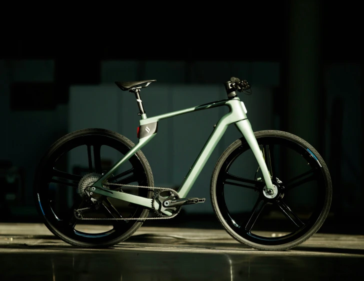 a bicycle in dark room with its wheel and kes on