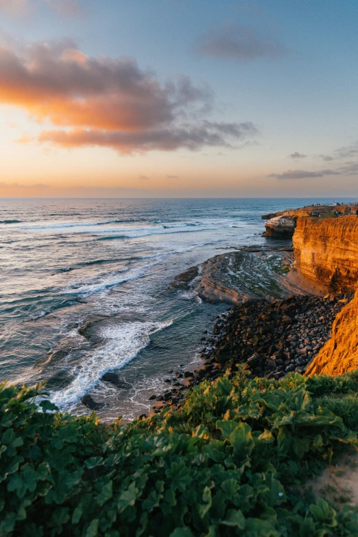 the view from an overlook of waves crashing onto the cliff