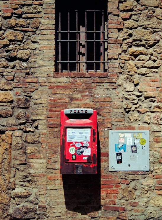 there is a post box outside next to an electrical box