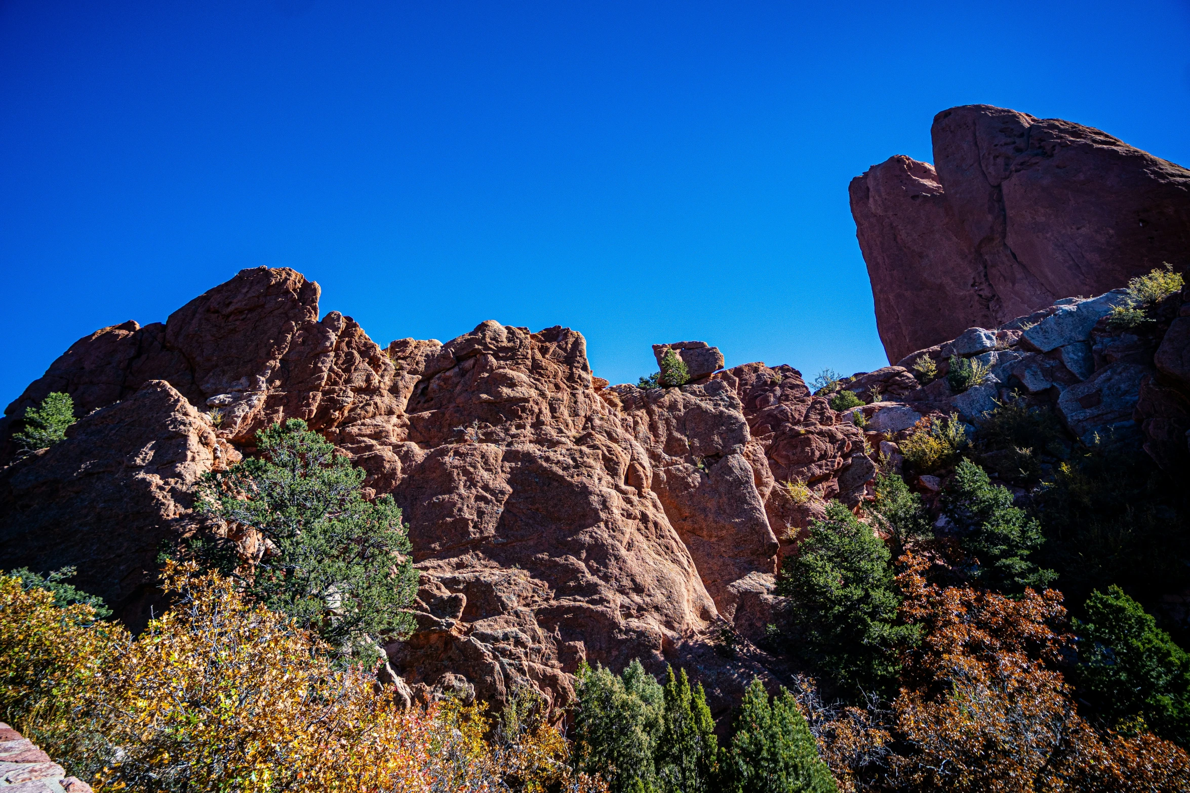 the mountains are lined with rocky peaks and trees