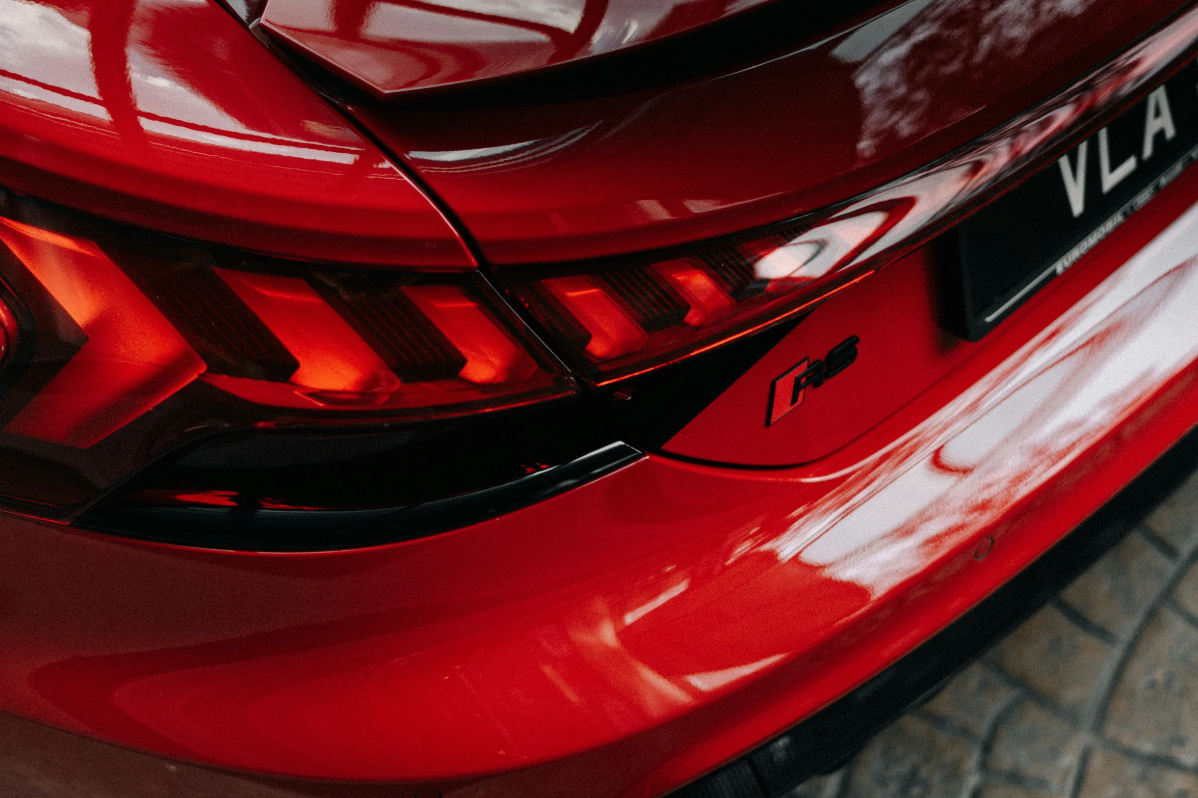 the rear end of a red car with lights