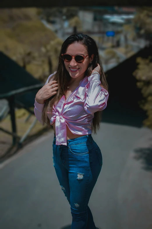 a woman is standing near a railing outside