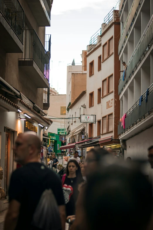 a very long crowded street with pedestrians