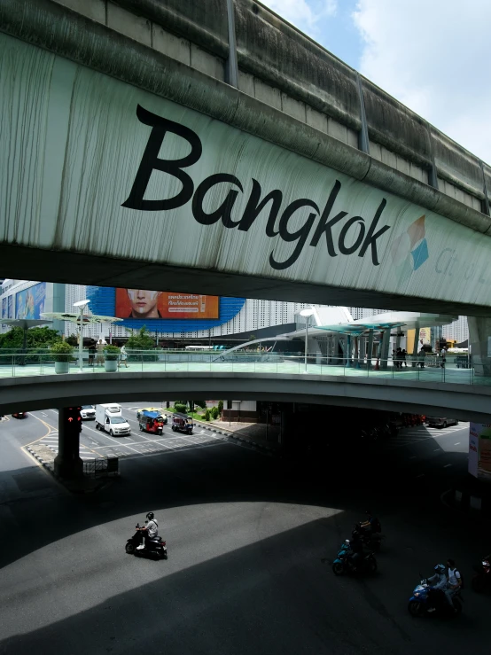 a large bridge over a street and lots of traffic