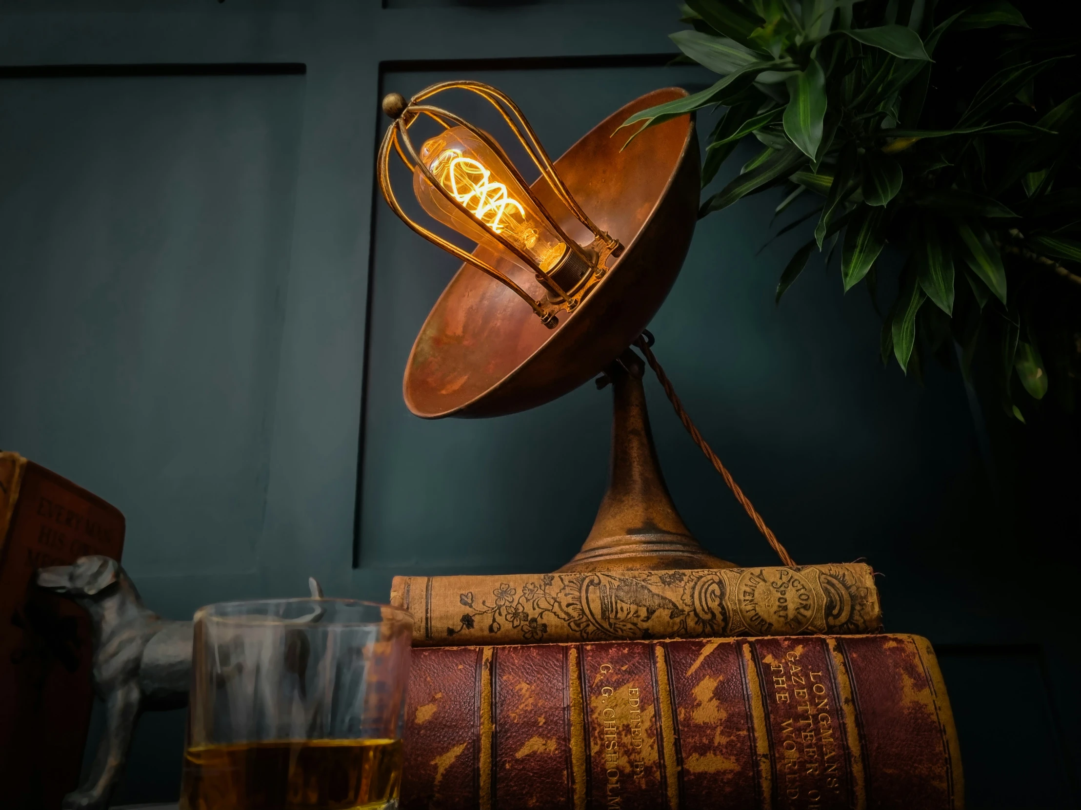 an odd looking light sitting on top of books