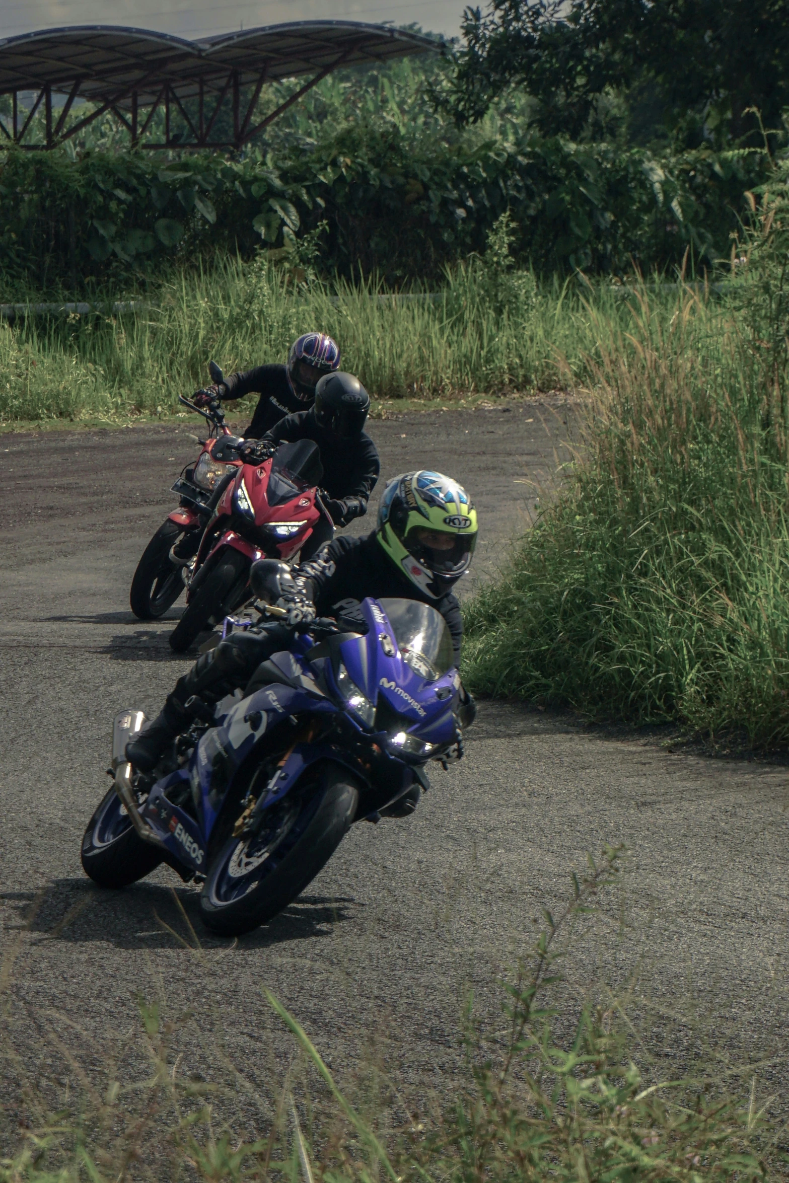 two people on motorcycles that are going down the road