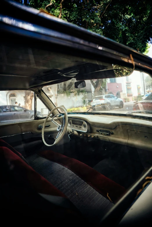 a view from a rear passenger's seat of an old car