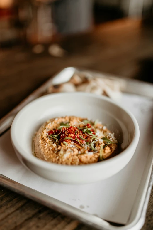 food on a white plate sits in the middle of a silver tray