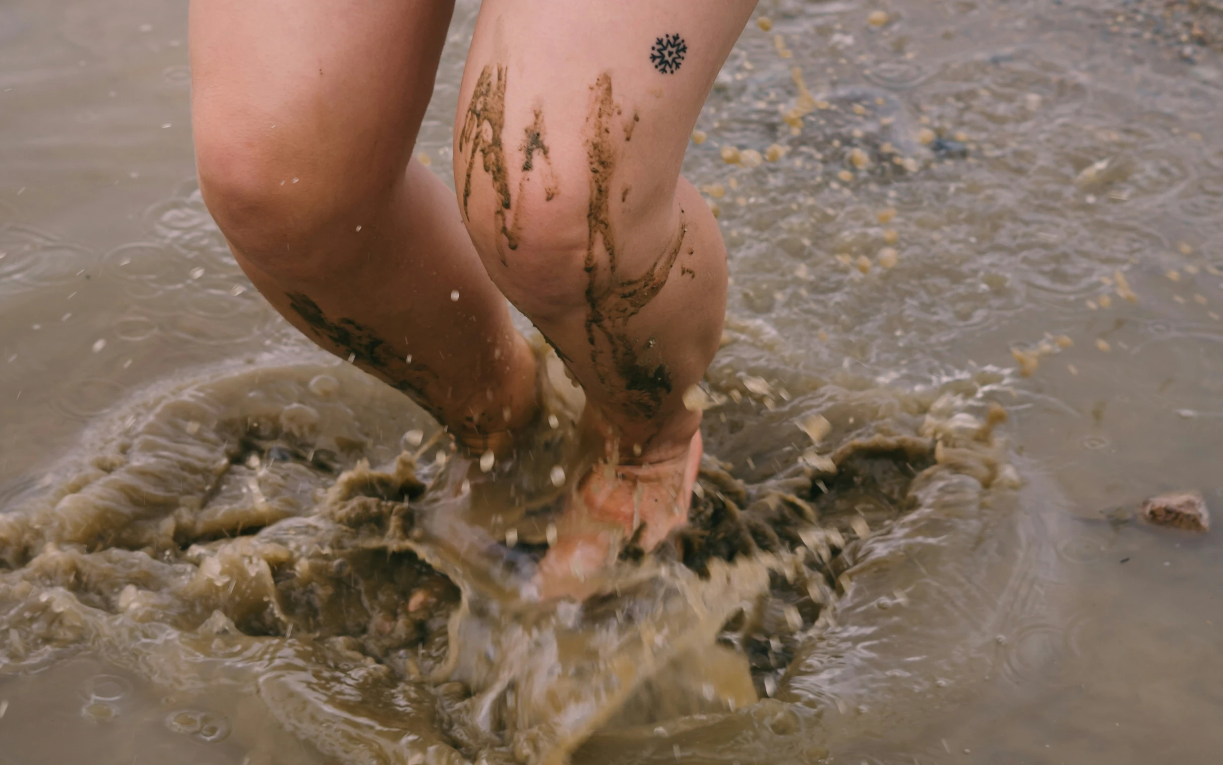 a person in some very dirty water and mud