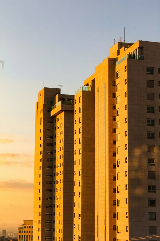 a tall building that is yellow and very high