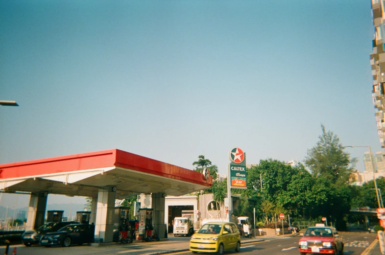 a gas station with cars parked in front of it