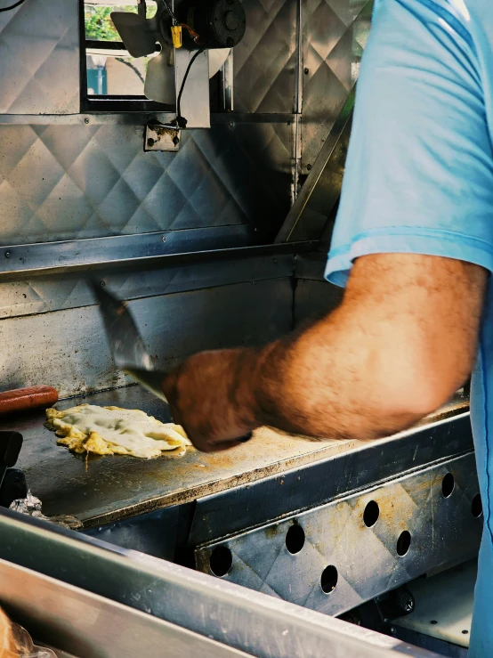 a man preparing food at a metal sink
