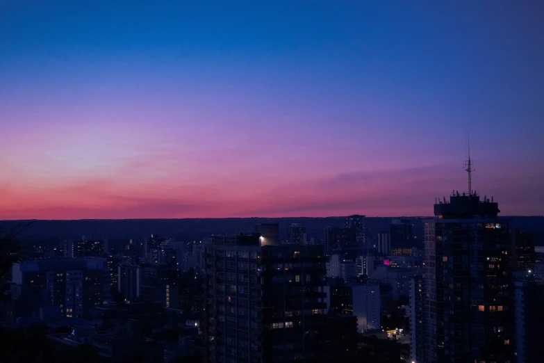 the view of a city at night from an observation platform