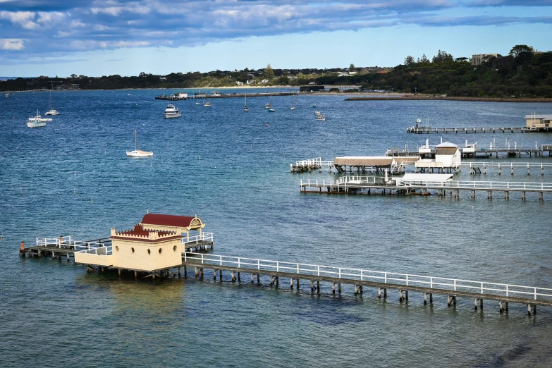 the water has several houses on it and the dock is surrounded by boats