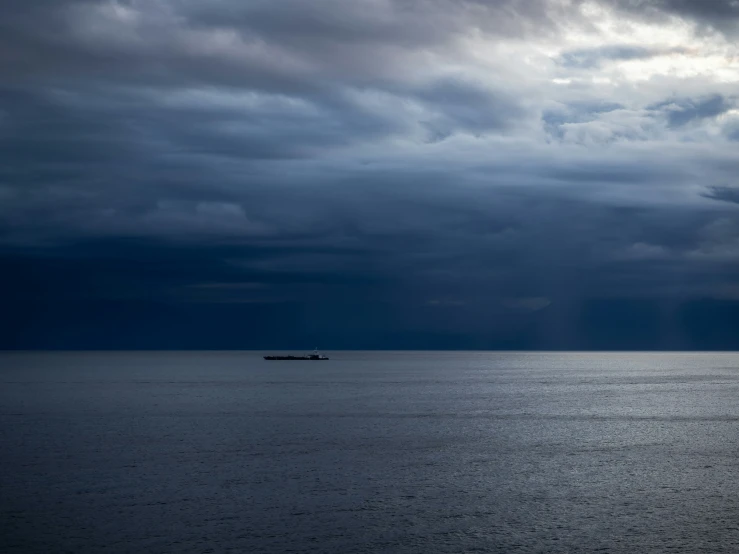 a boat that is out on the water under some clouds