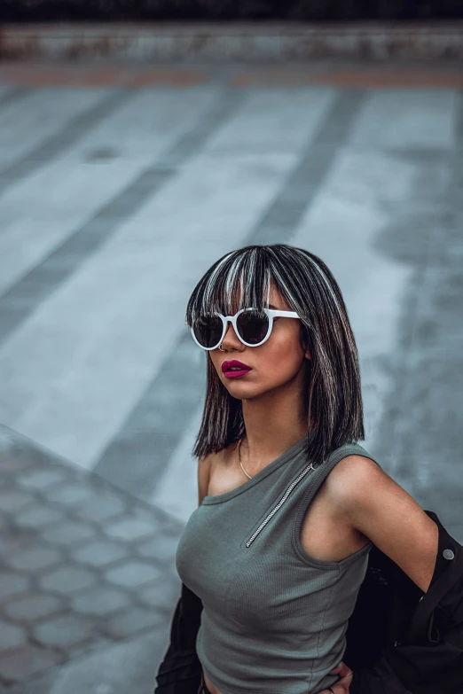 a girl with sunglasses on is posing for a picture