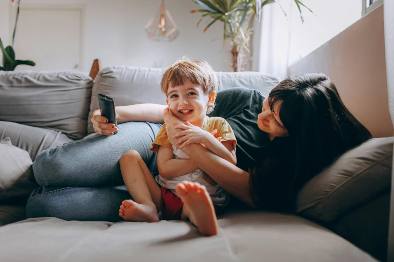 an older woman laying on the sofa with a younger man