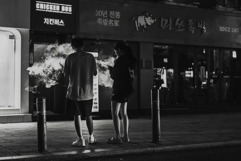 two people standing in the street looking at soing