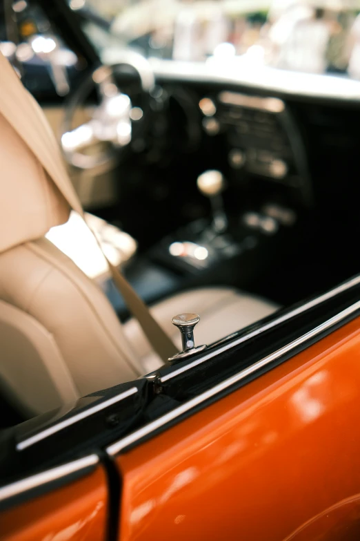 an orange car with black trim and a small diamond on the seat