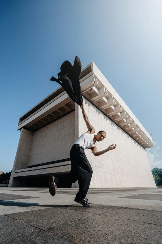 a man dancing outside of an older building