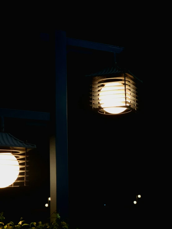 two light bulbs with a roof and lights