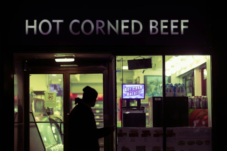 a man walking out of a  corned beef restaurant