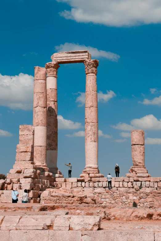 there are some people standing outside by a tall column