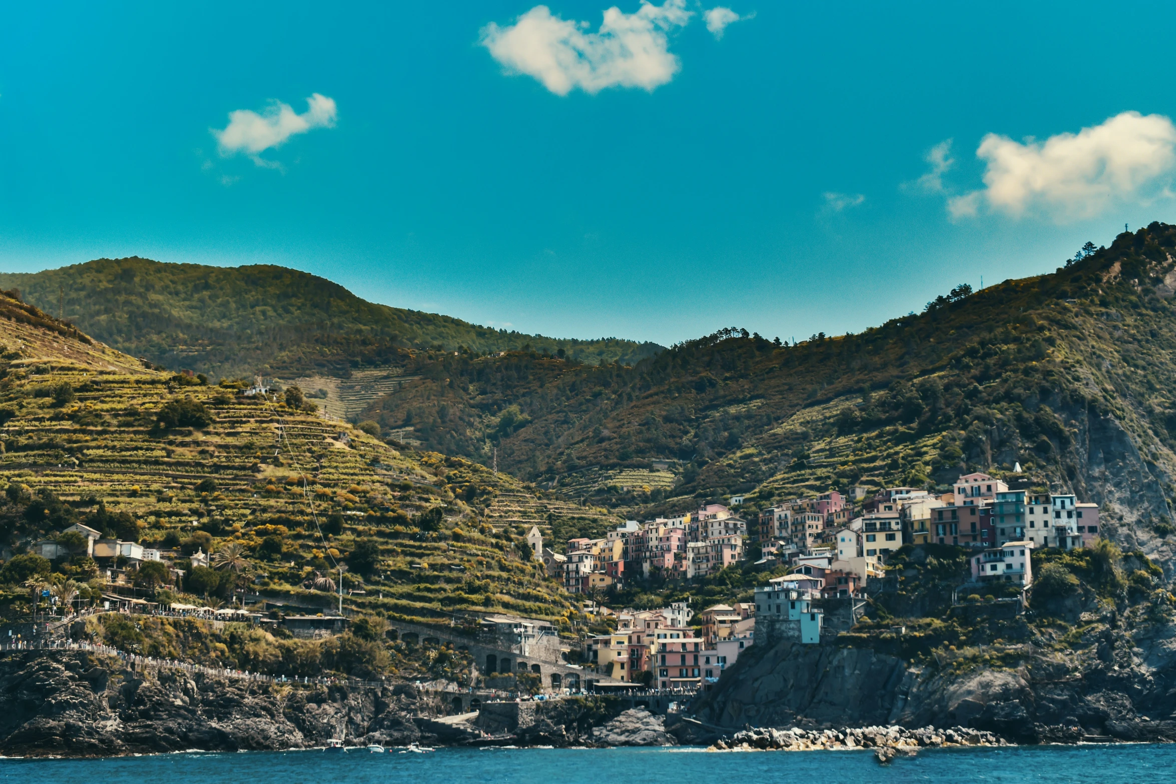 the mountains surrounding a small town by the ocean