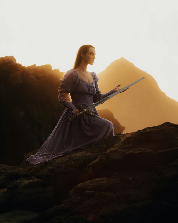 the beautiful lady in a long dress is holding a sword