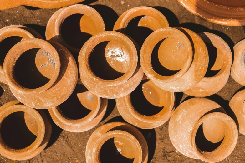 pots and bowls with some brown paint on them