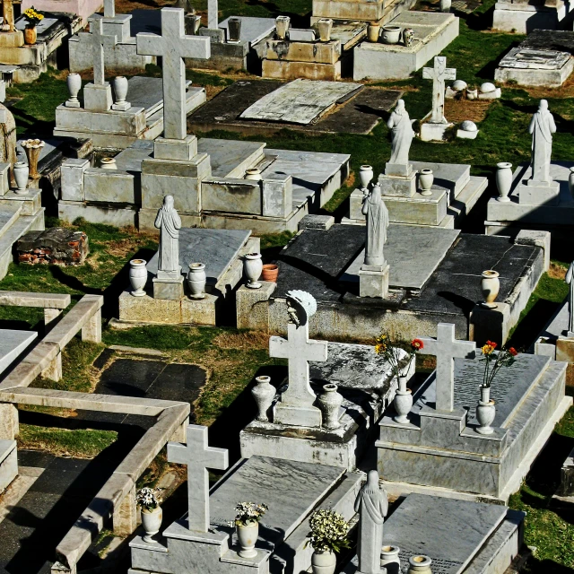 graves and gravestones are lined up in the grass