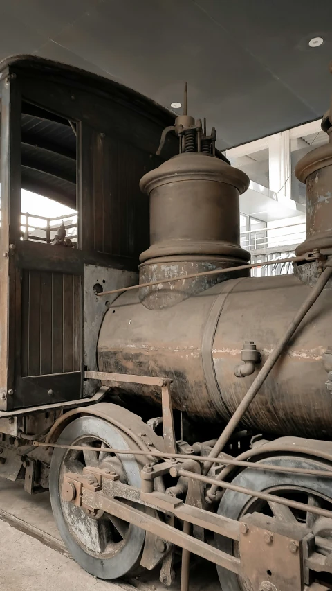 a steam train sits in the old train depot