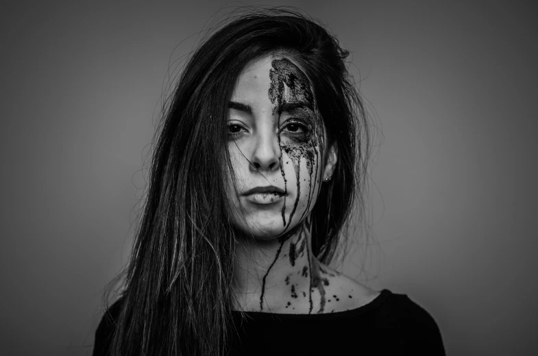 an attractive young woman with makeup splattered on her face