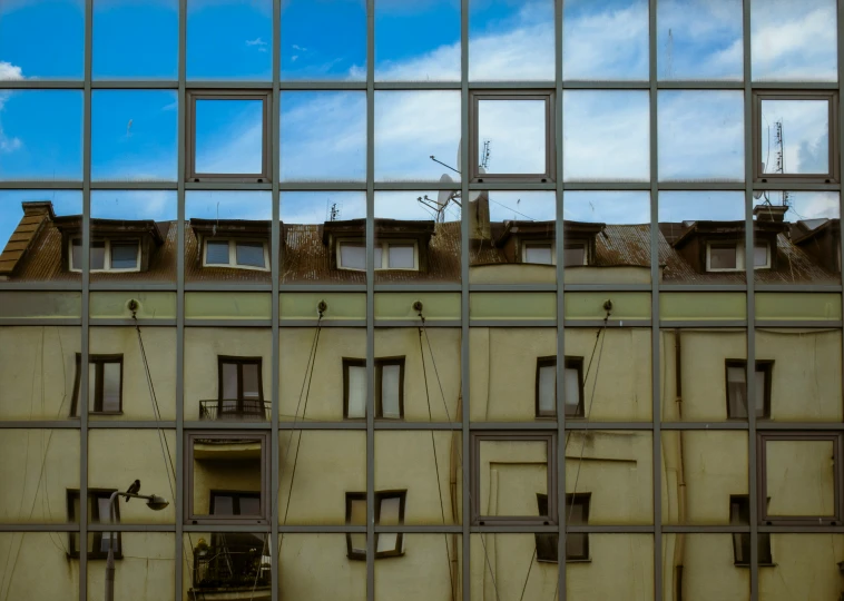 view through the bars to the sky with a row of windows