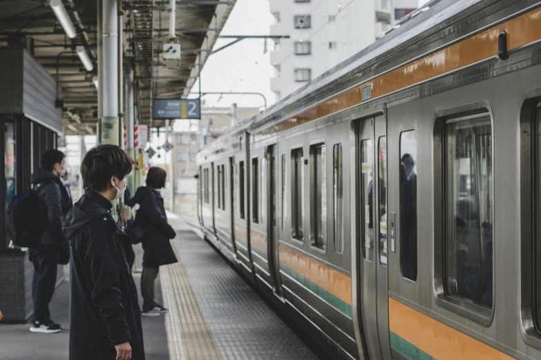 a yellow and white train parked at the platform