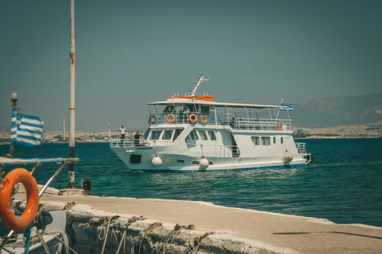 a white boat sailing in the water next to another boat