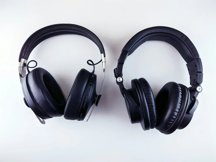 two black headphones that are next to each other