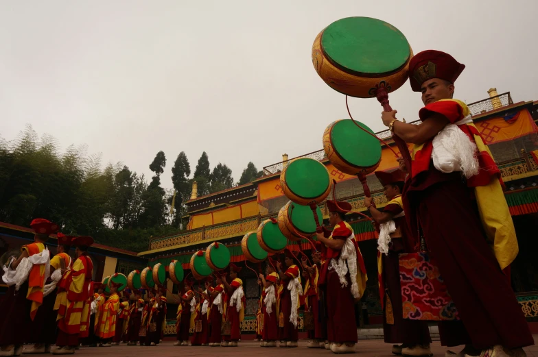 group of people with musical instrument playing in front of building