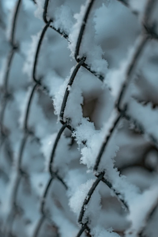 a barbed wire fence covered in snow