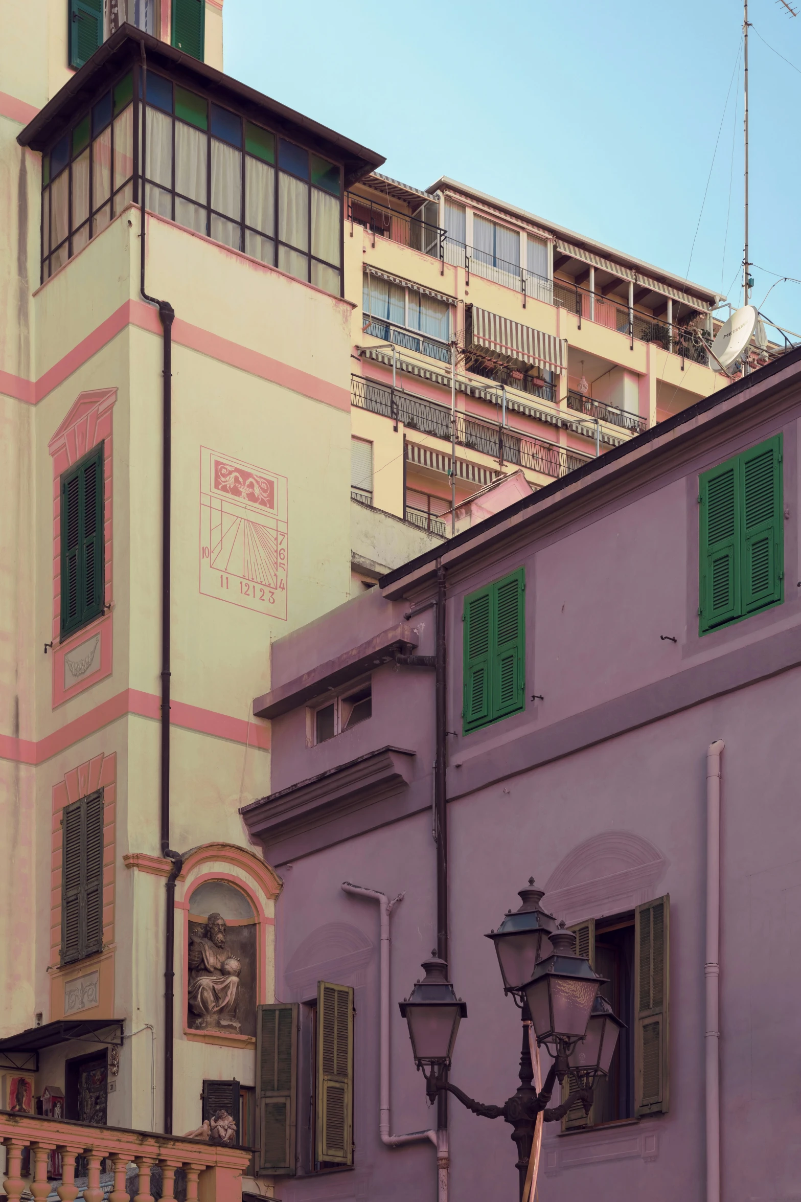 a building that has windows on one side and shutters on the other