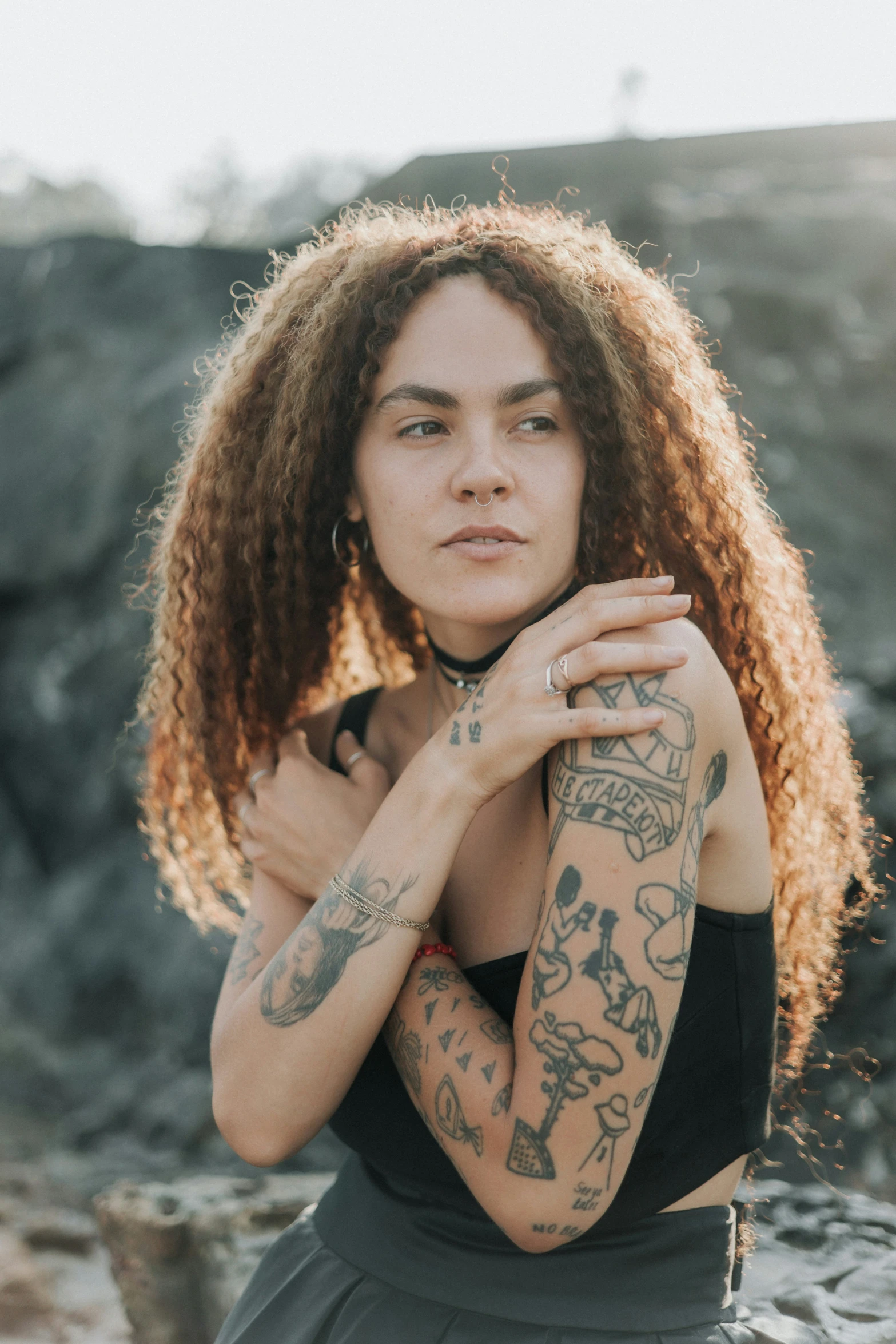 a young woman with tattoos posing for a po