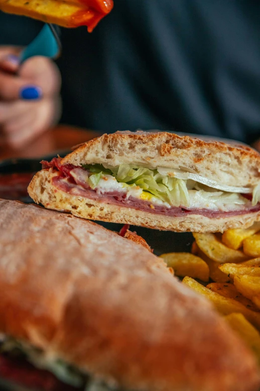 the sandwich on the plate is cut in half and ready to eat