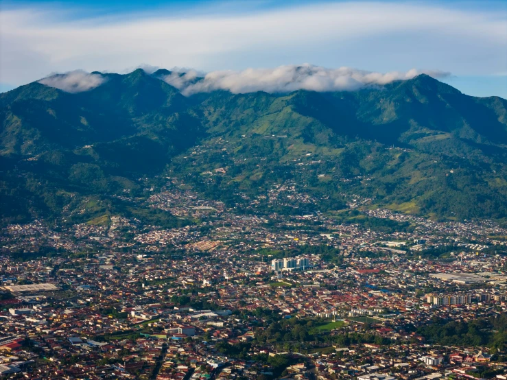 an aerial view of a town surrounded by mountains