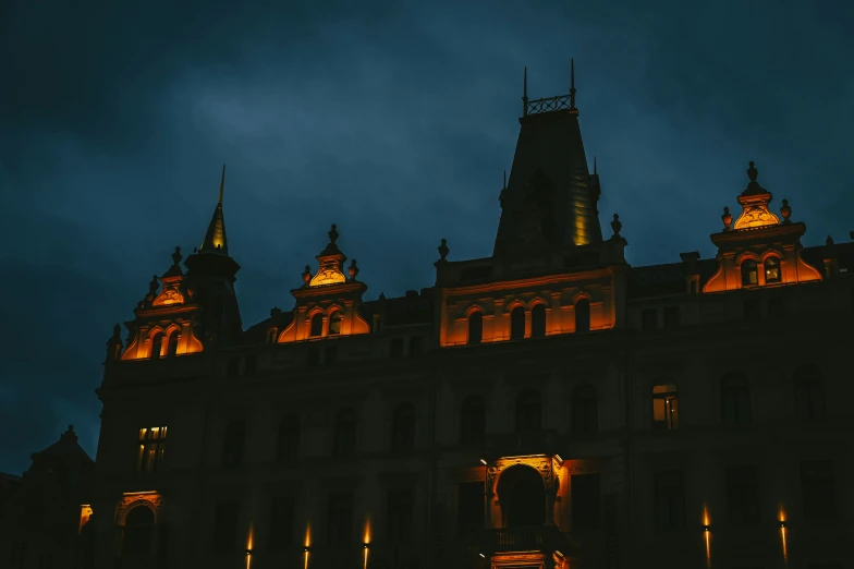 a tall building with spires lit up at night