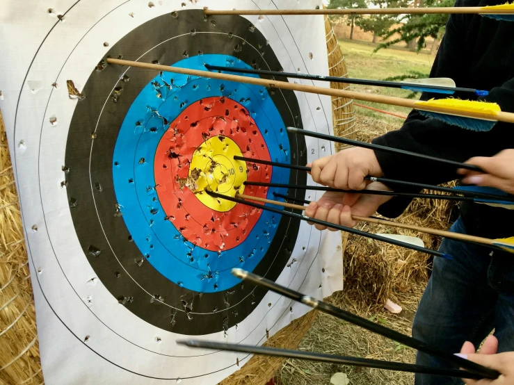 people with arrows shooting on the side of a white flag