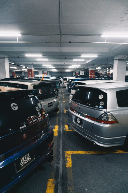 several cars parked in a large garage