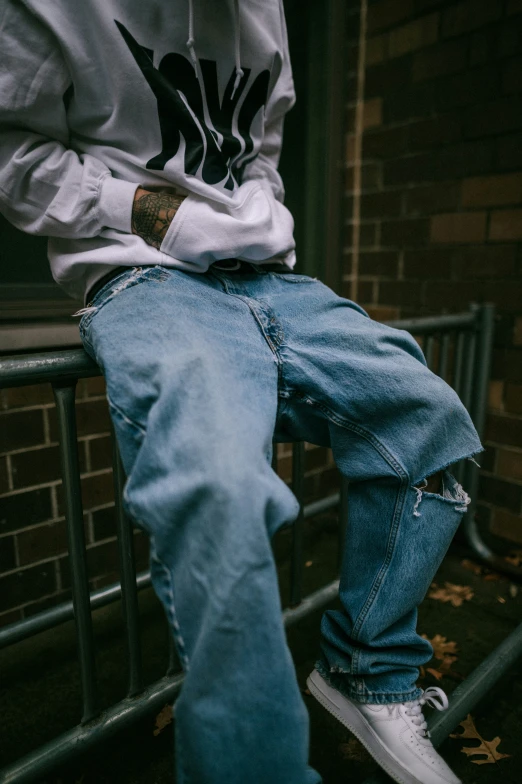 a man is posing on his skateboard by the rail